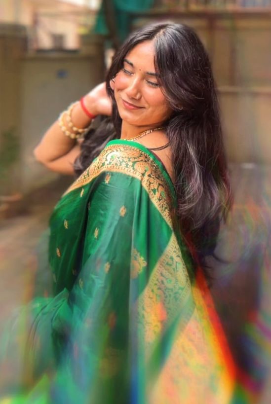 Woman in a green Paithani saree in golden light